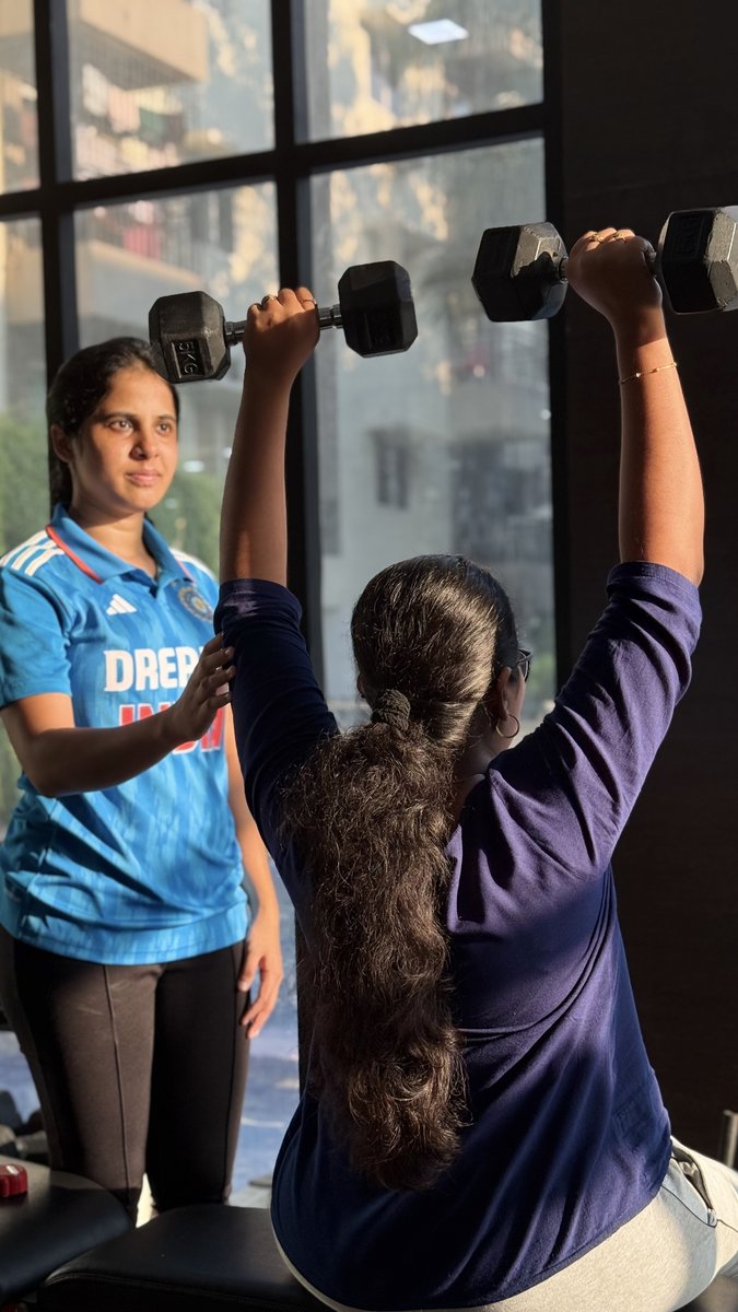 Nandhini guiding a client through an exercise